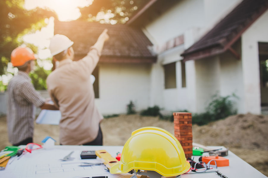 Contractors Discussing House Details.